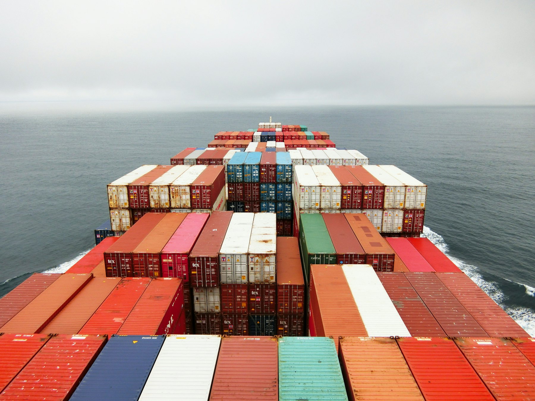 Container ship at sea viewed from the bow, loaded with freight containers